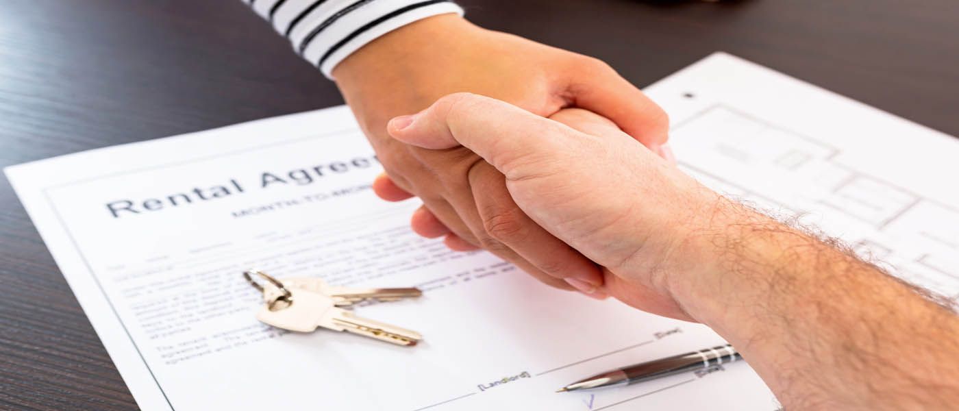 Shaking hands over rental agreement