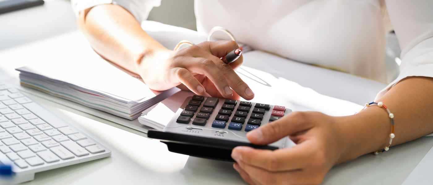 Woman Budgeting With Calculator